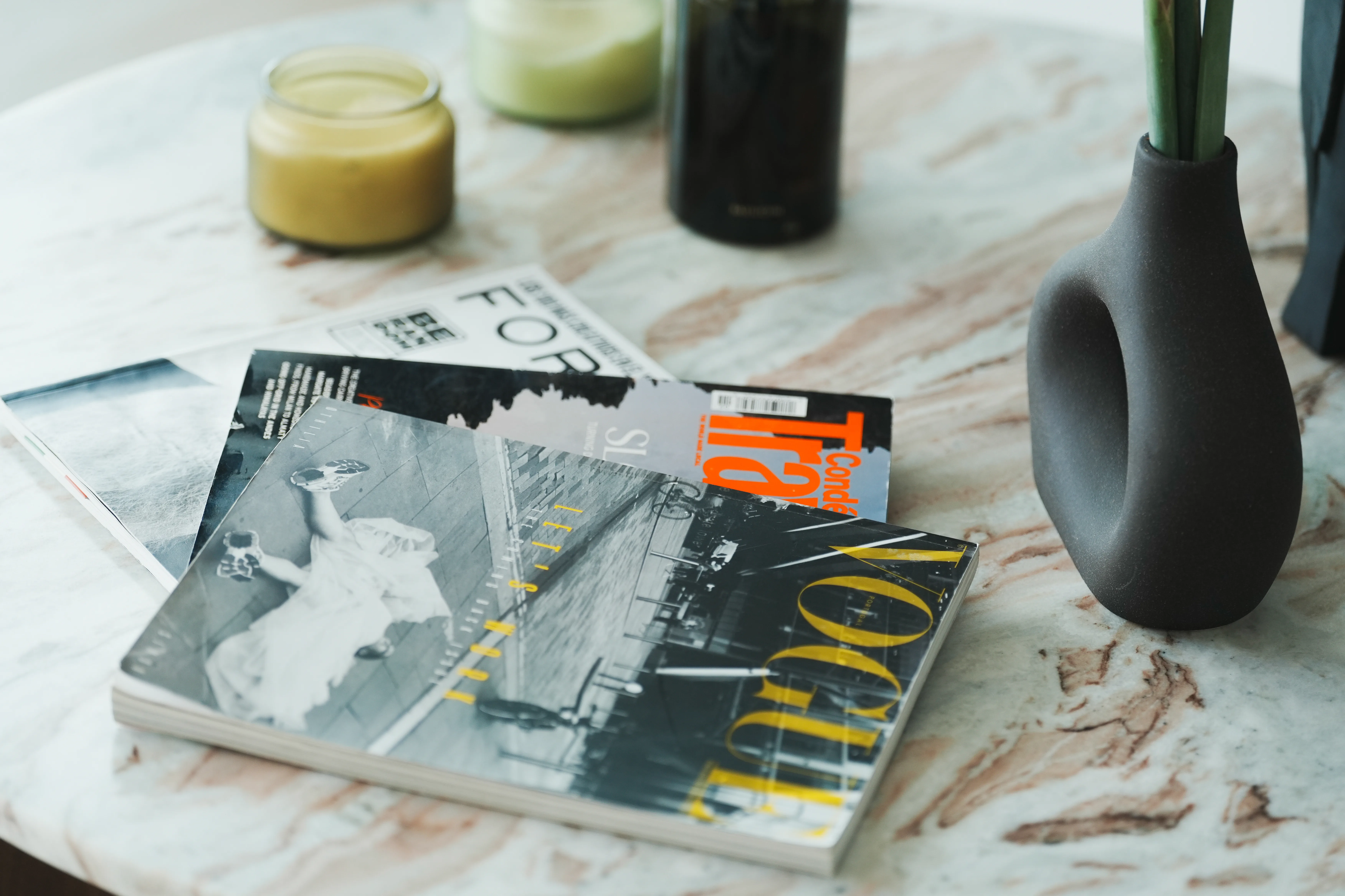 Magazines and candles left out on the table